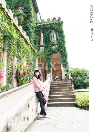 A Japanese woman walks through the castle in the forest. The woman wore a hat. A Japanese woman walks through the castle in the forest. The woman wore a hat. 57745116