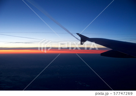 FRANKFURT, GERMANY - JAN 20th, 2017: View on the sunset, germany during winter and airplane wing 57747269