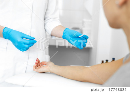The girl prepared a hand for blood sampling from 57748025