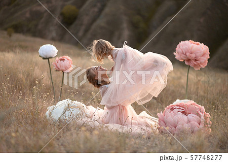 Mom and daughter in pink fairy-tale dresses play Mom and daughter in pink fairy-tale dresses play 57748277