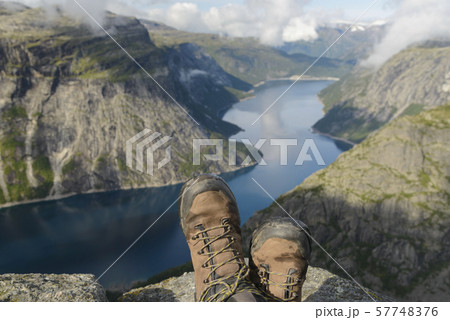 Two feet with hiking boots on them against 57748376