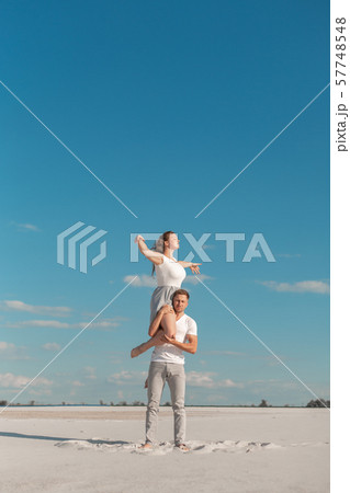 Romantic couple dancing in sand desert at blue sky Romantic couple dancing in sand desert at blue sky 57748548