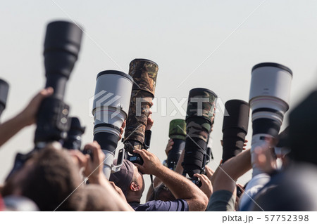 Photographers taking a shot of the airplanes - many professional lenses 57752398