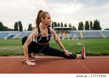 Female runner in sportswear, workout on stadium Female runner in sportswear, workout on stadium 57755646