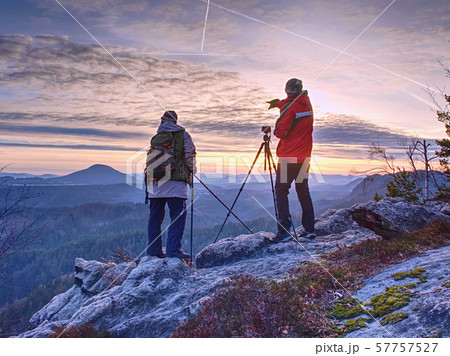 Nature photographers with big camera on tripod on Nature photographers with big camera on tripod on 57757527