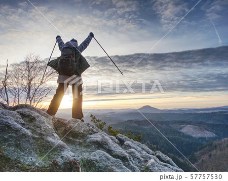 Woman reached mount peak. Girl wears backpack and 57757530