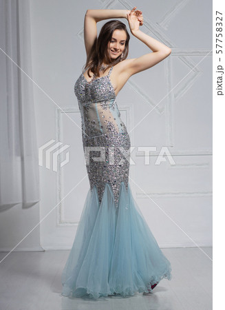 Sexy young woman poses in a studio dressed. Sexy young woman poses in a studio dressed. 57758327