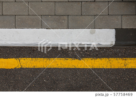 Yellow line of road marking along the pavement 57758469