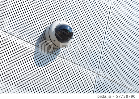 Close-up of cctv system camera on white metal surface with a lot of tiny round openings 57758790