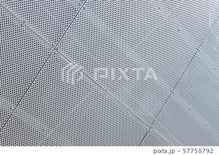 Close-up of white metal surface with a lot of tiny round openings Close-up of white metal surface with a lot of tiny round openings 57758792