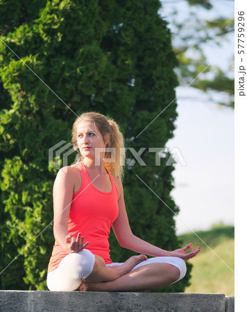 Woman Doing Yoga in the Park Woman Doing Yoga in the Park 57759296