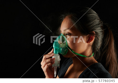 Woman face with nebulizer mask 57760345