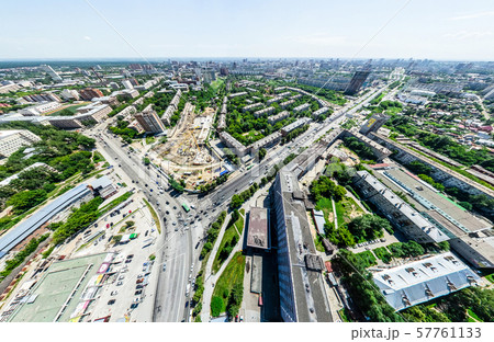 Aerial city view with crossroads and roads, houses, buildings, parks and parking lots. Sunny summer 57761133