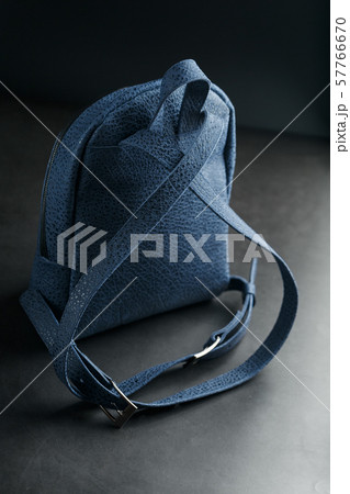 Blue backpack made of genuine leather on a dark Blue backpack made of genuine leather on a dark 57766670