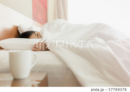 Woman stretching in bed after waking up, back 57769376