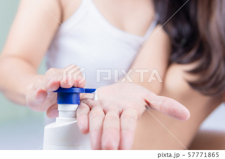 A beautiful Asian woman sitting on a bed pressing A beautiful Asian woman sitting on a bed pressing 57771865