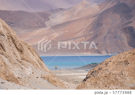Pangong Lake with rocky mountains situated on the Pangong Lake with rocky mountains situated on the 57773988