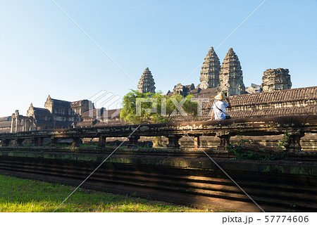 One tourist visiting Angkor ruins amid jungle, 57774606