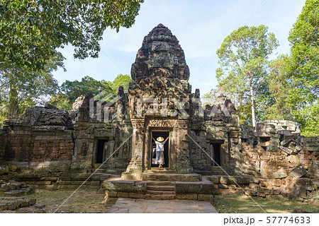 One tourist visiting Angkor ruins amid jungle, One tourist visiting Angkor ruins amid jungle, 57774633