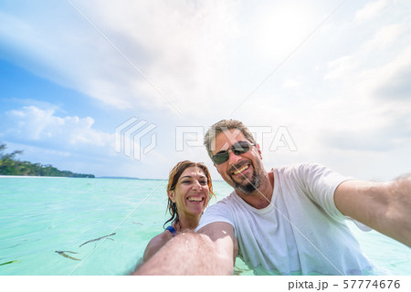 Happy man and woman taking selfie in tropical Happy man and woman taking selfie in tropical 57774676