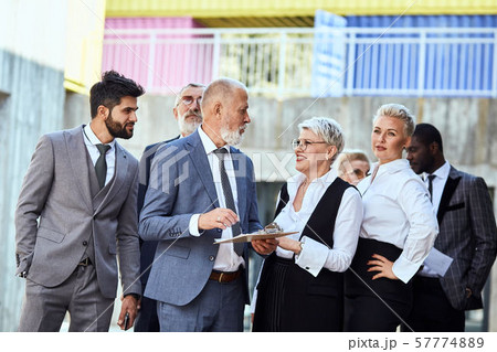 Group of businessmen walking down the street 57774889