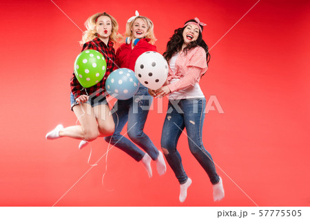 Laughing woman having fun jumping and smiling with 57775505