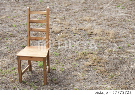 wooden chair dry grass background 57775722