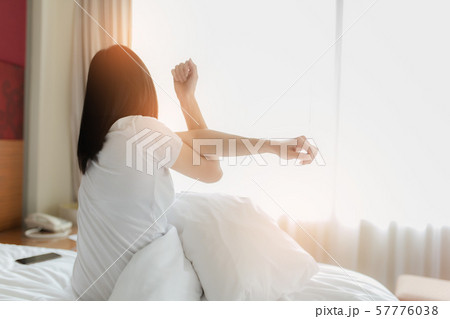 Woman stretching in bed after waking up, back 57776038