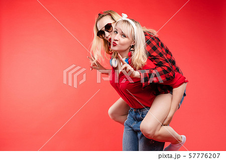 Sisters having fun giving piggyback.Stock studio Sisters having fun giving piggyback.Stock studio 57776207