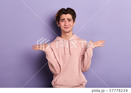 Closeup portrait of puzzled clueless young man shrugging his shoulders 57776239
