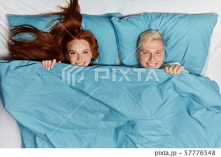 positive blonde man and ginger woman lying on the bed positive blonde man and ginger woman lying on the bed 57776548