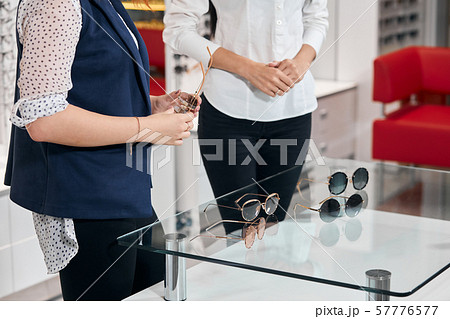 focus on different glasses, sunglassses lying on the glass table 57776577