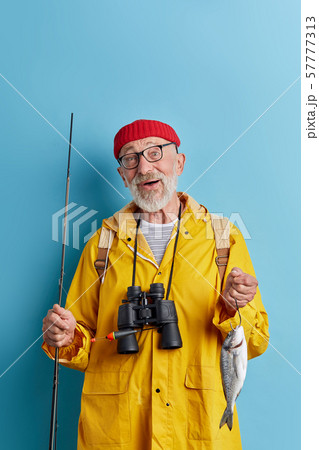 old cheerful man enjoying his fist catch old cheerful man enjoying his fist catch 57777313