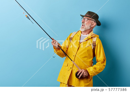 crazy funny smiling old fisheman enjoying hobby 57777386