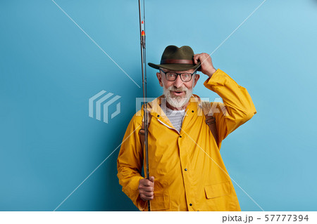 cheerful old man has noticed a big fish in the lake 57777394