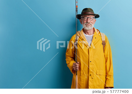 bearded old man in glasses going fishing 57777400