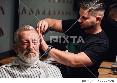 secrets of trendy haircut.handsome old man getting his hair done secrets of trendy haircut.handsome old man getting his hair done 57777420