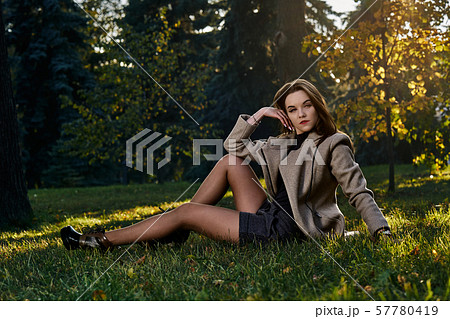 A young woman with long hair and in a woolen coat 57780419