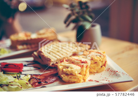 breakfast with scrambled eggs, toasts, juice and coffee 57782446