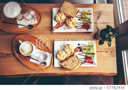 breakfast with scrambled eggs, toasts, juice and coffee 57782450