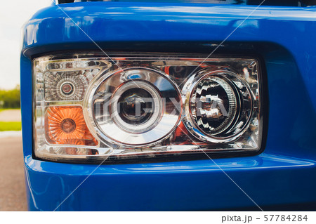 closeup photo of spotlight and wheels of tractor. 57784284