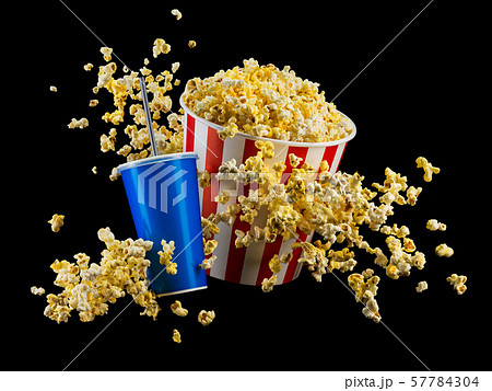 Set of paper striped bucket with popcorn and cup of soft drink isolated on black 57784304