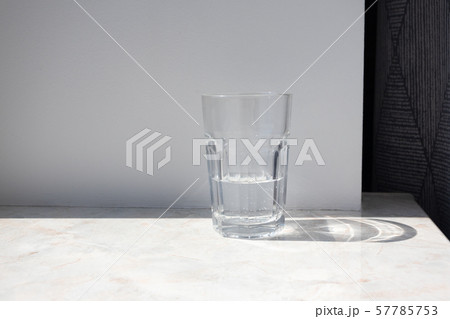 Glass of pure water on a granite table against Glass of pure water on a granite table against 57785753