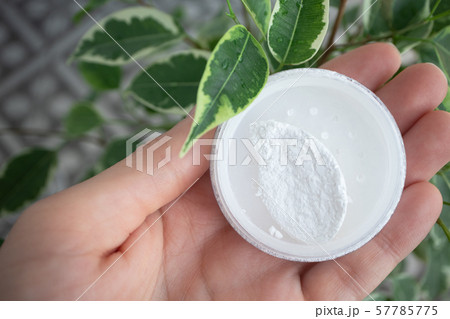 Round box of mineral powder in female palm in 57785775