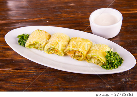 The fried vegetable marrows with garlic and greens, move with sour cream The fried vegetable marrows with garlic and greens, move with sour cream 57785863