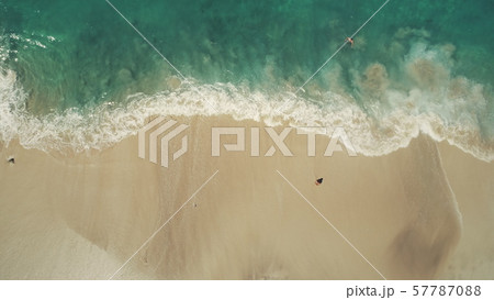 Top down view ocean beach waves break white sand 57787088