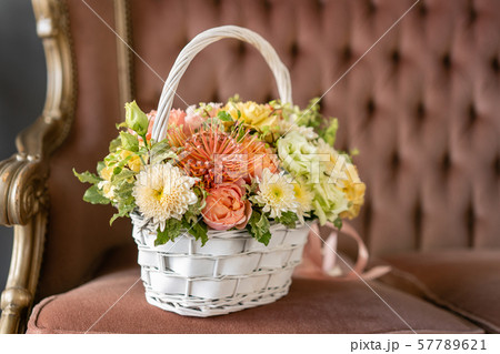 Beautiful flower composition a bouquet in a wicker basket. Floristry concept. Spring colors 57789621