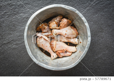 raw chicken with legs and wings with herbs and 57789671