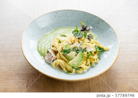 Italian pasta tagliatelle with zucchini, Turkey and green sauce. Parmesan cheese Italian pasta tagliatelle with zucchini, Turkey and green sauce. Parmesan cheese 57789746