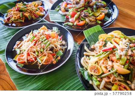 Papaya salad served on dining table / Green papaya Papaya salad served on dining table / Green papaya 57790258
